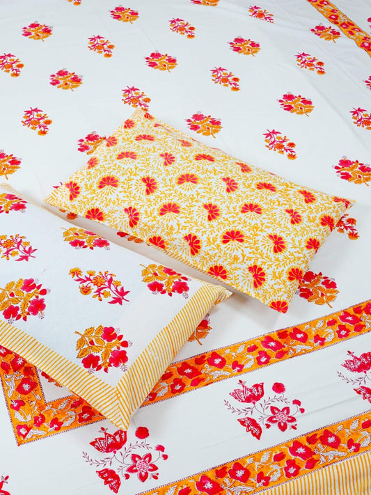 Floral patterned fabric with red and yellow flowers on a white background