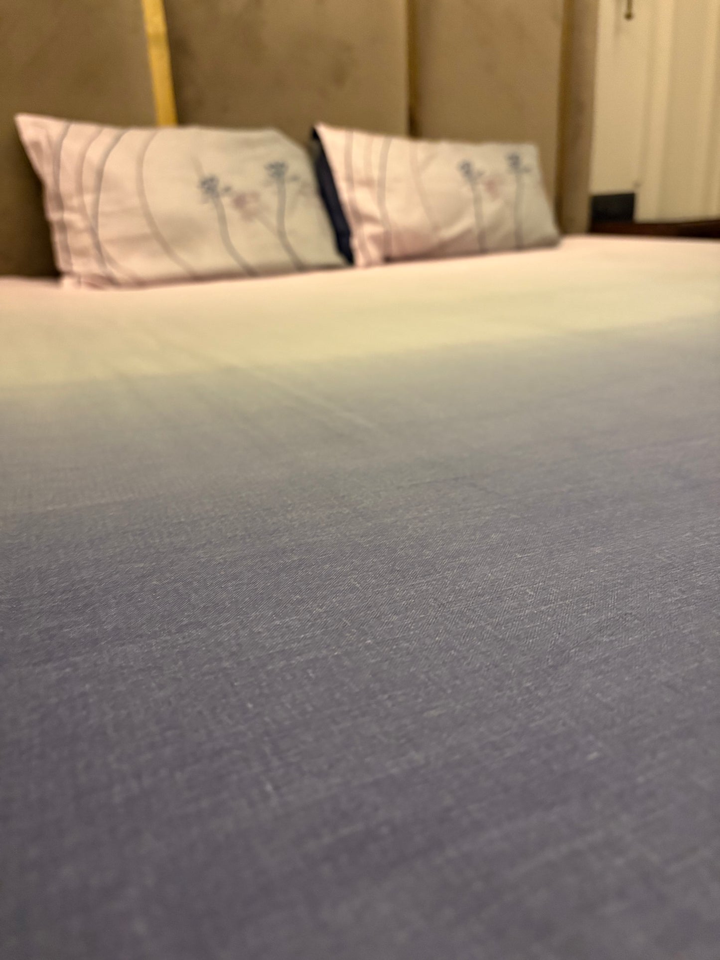 A close-up of a neatly made bed with the Percale Ombre 250 TC Bedsheet + Pillow Cover Pair Set (108x108 - King Size) in Navy Blue Ombre, featuring gradient tones and crafted from 100% long-staple cotton.