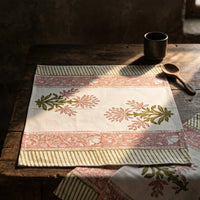 Decorative tablecloth with floral patterns on a wooden table. Hand block printed table runner and table mats set 100% cotton.