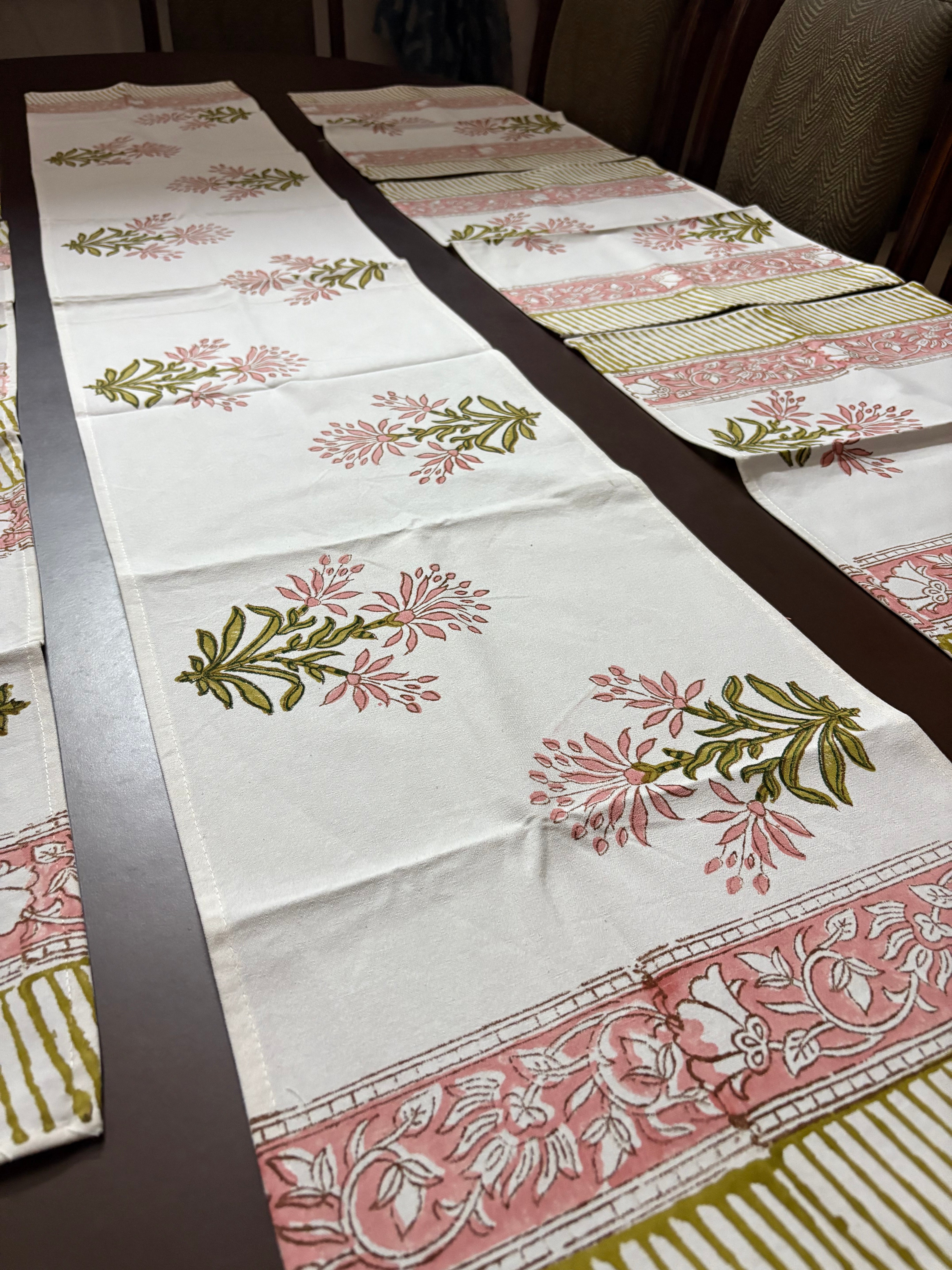 Floral patterned table runner on a wooden surface block printed jaipuri table linen set made in india