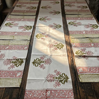 Set of floral-patterned block printed table runners on a wooden table