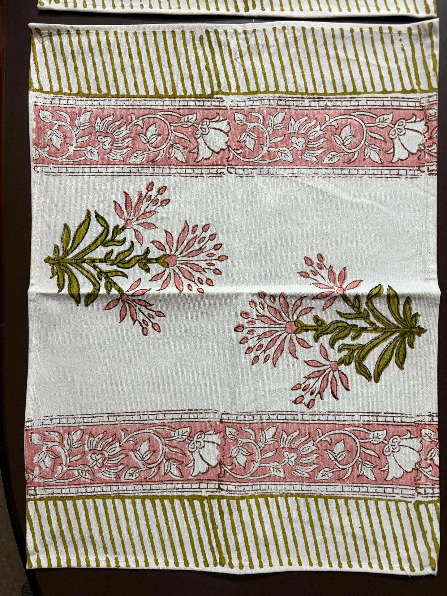 Decorative fabric with floral and leaf patterns on a white background