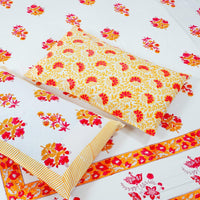 Floral patterned fabric with red and yellow flowers on a white background