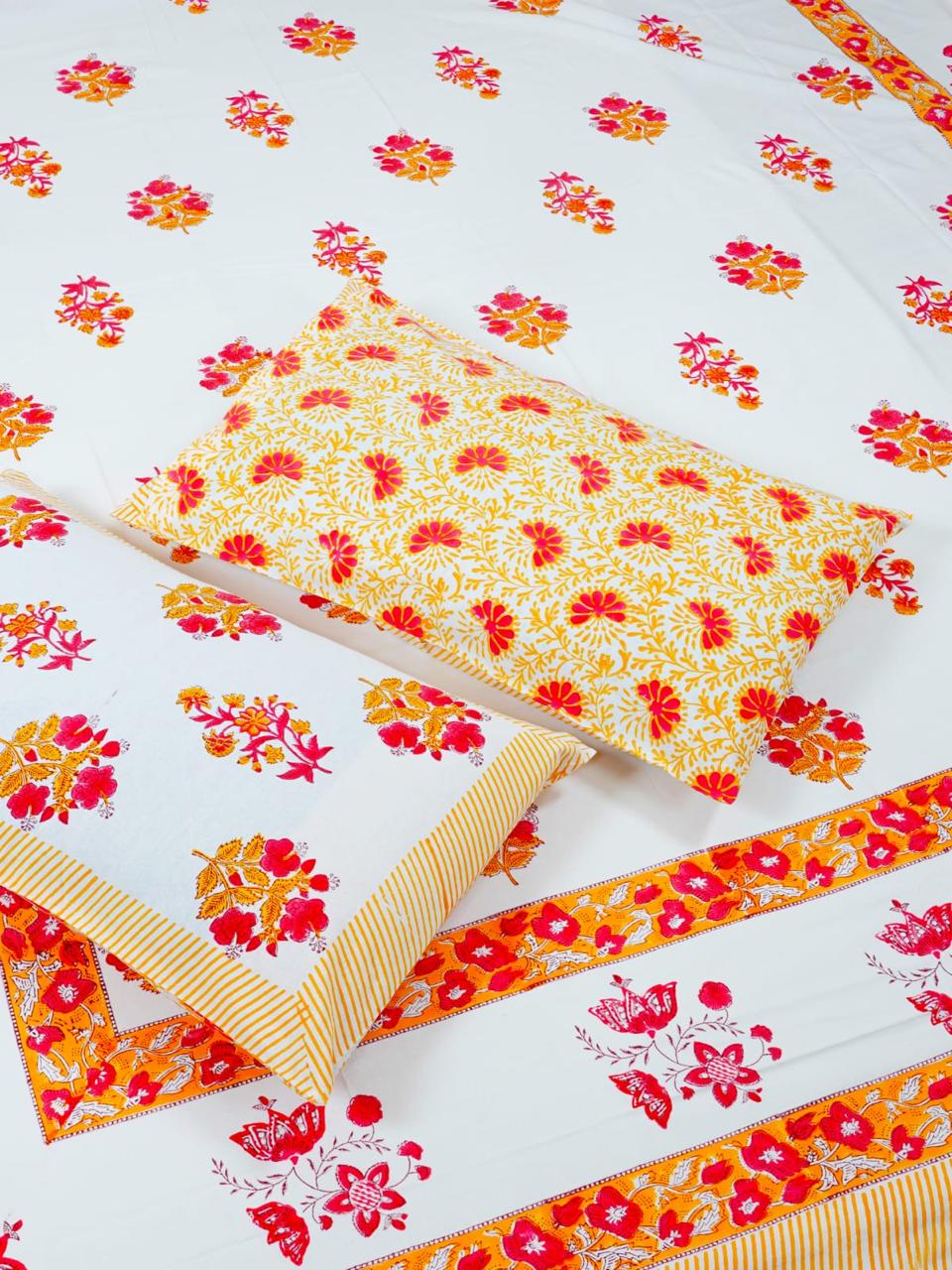 Floral patterned fabric with red and yellow flowers on a white background