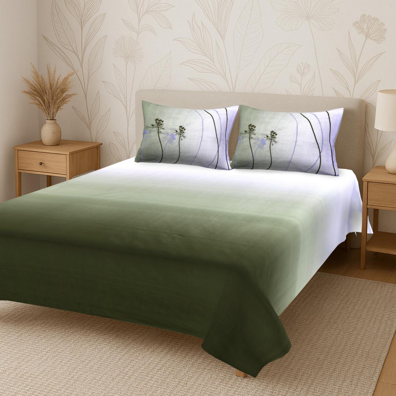 A neatly made bed with the Percale Ombre 250 Tc Bedsheet + Pillow Cover Pair Set (King Size), accented by two floral pillows. Light wooden nightstands, a vase with dried grass, lamp, and subtle leaf wallpaper complete the cozy look.