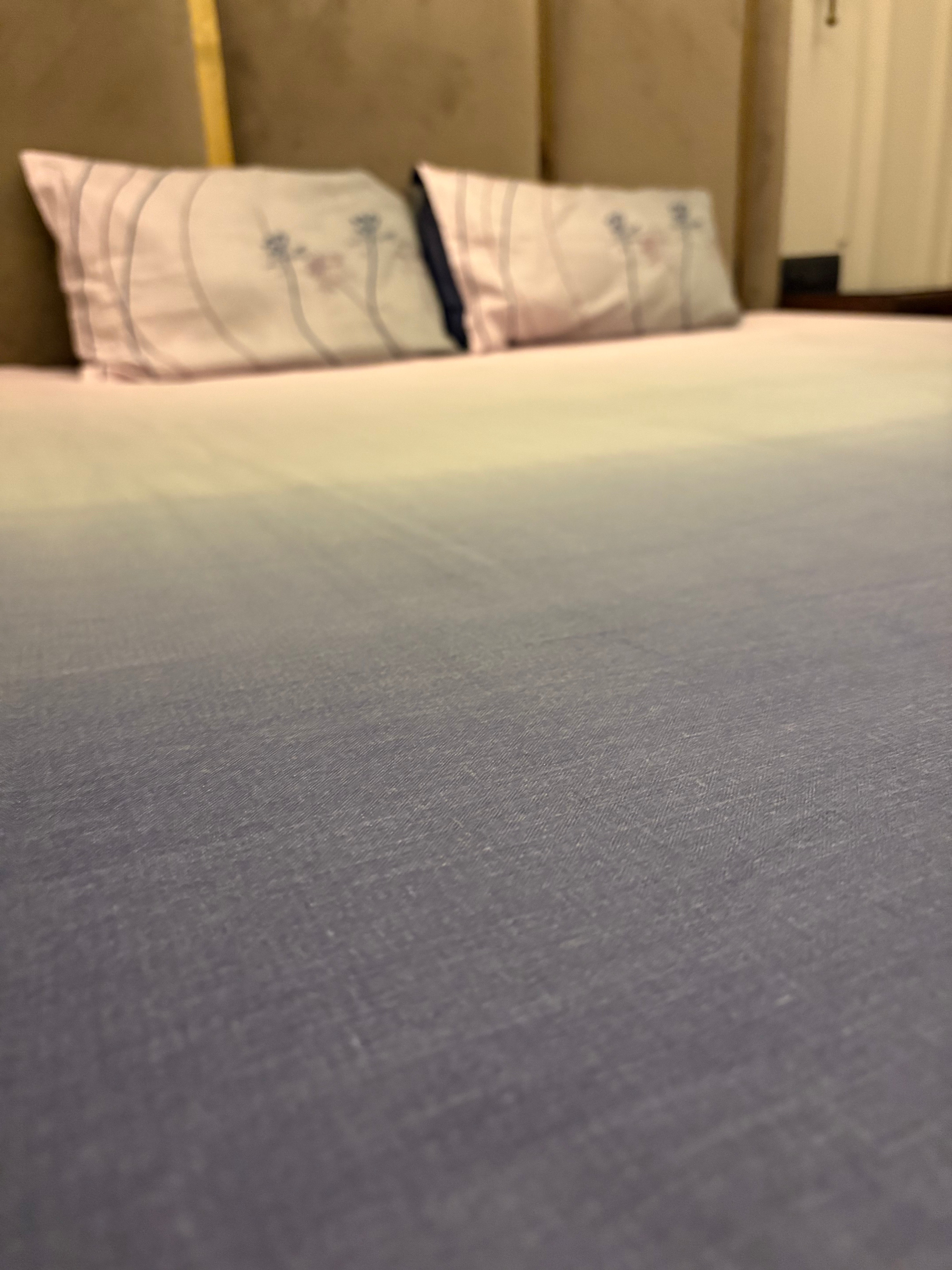 A close-up of a neatly made bed with the Percale Ombre 250 TC Bedsheet + Pillow Cover Pair Set (108x108 - King Size) in Navy Blue Ombre, featuring gradient tones and crafted from 100% long-staple cotton.