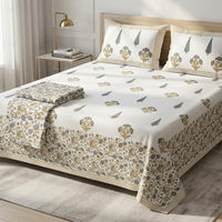 Bed with floral-patterned hand block printed bedding in a well-lit bedroom